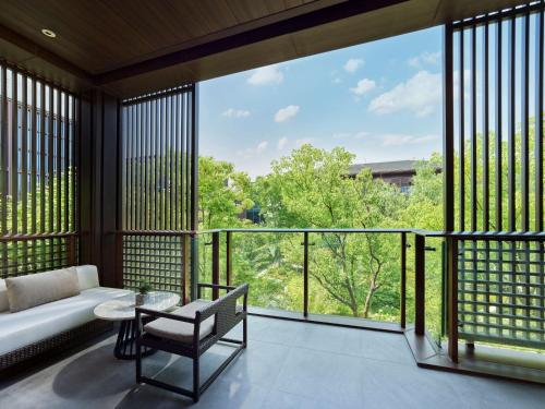 a living room with a couch and a table at Hilton Shanghai Songjiang Guangfulin in Songjiang