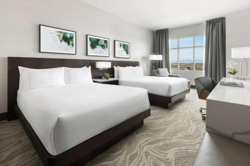 a hotel room with two beds and a desk at Doubletree By Hilton Tucson Downtown Convention Center in Tucson