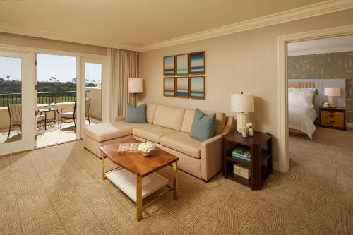 a living room with a couch and a table at Waldorf Astoria Monarch Beach Resort & Club in Dana Point