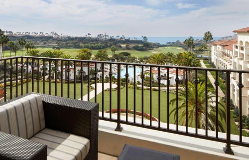a balcony with a view of a golf course at Waldorf Astoria Monarch Beach Resort & Club in Dana Point