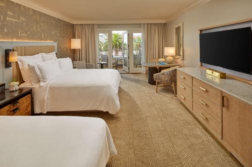 a hotel room with two beds and a flat screen tv at Waldorf Astoria Monarch Beach Resort & Club in Dana Point