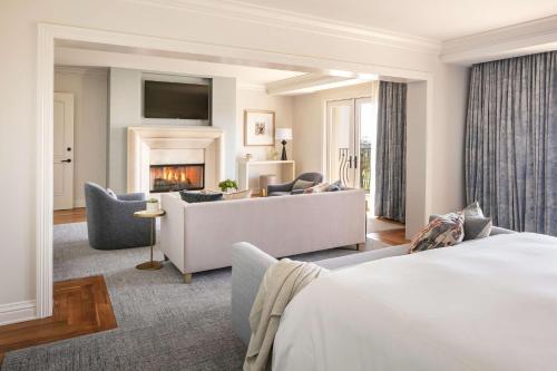 a hotel room with a couch and a fireplace at Waldorf Astoria Monarch Beach Resort & Club in Dana Point