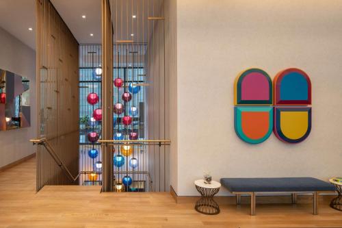a lobby with a bench and a christmas tree at Motto by Hilton New York City Chelsea in New York