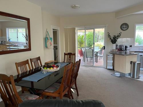 a kitchen and dining room with a table and chairs at Bagnalls beach house in Corlette