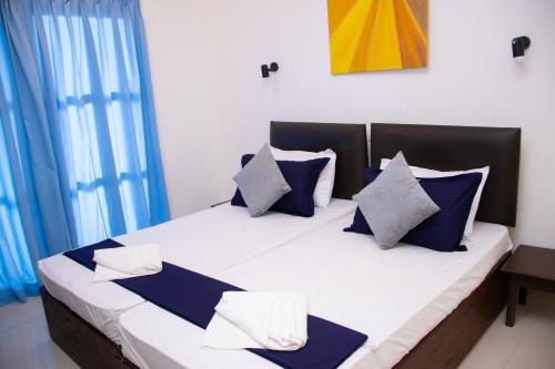 Postel nebo postele na pokoji v ubytování Woodnest Windmill Beach Hotel