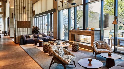 a living room filled with furniture and a fireplace at Conrad Los Angeles in Los Angeles