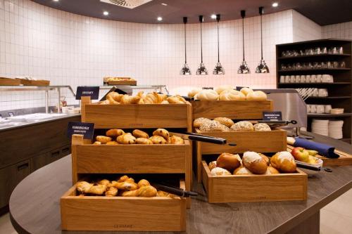 a bakery with several boxes of bread on a table at Hampton By Hilton Regensburg in Regensburg