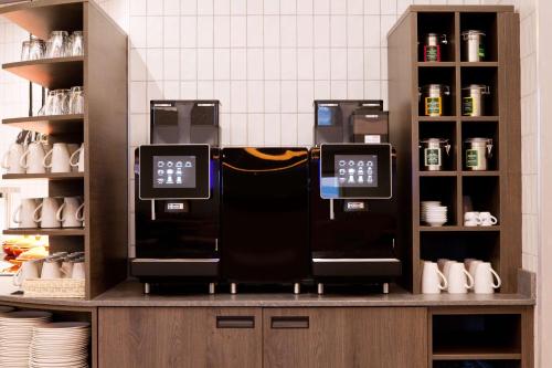 two coffee machines on a counter in a kitchen at Hampton By Hilton Regensburg in Regensburg