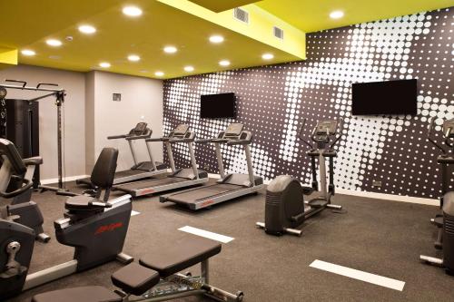 a gym with several treadmills and exercise machines at Hampton By Hilton Regensburg in Regensburg