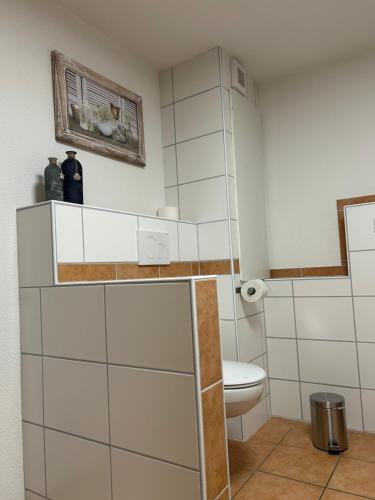 a bathroom with a toilet and a sink at Gästehaus Maxi in Rust