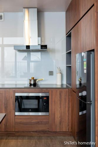 a kitchen with wooden cabinets and a microwave at Pentstudio 1a in Hanoi
