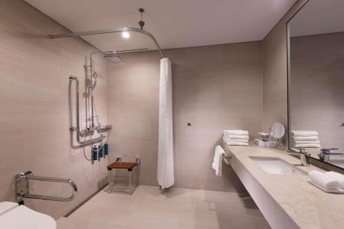 a bathroom with a shower and a sink at DoubleTree By Hilton Seoul Pangyo in Seongnam