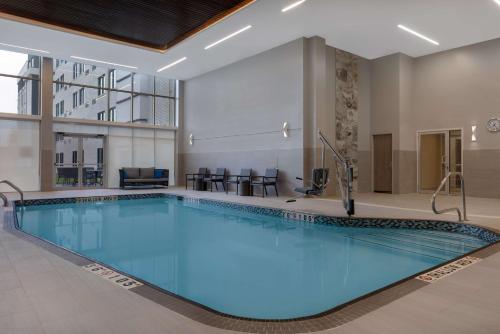 a large swimming pool in a hotel lobby at DoubleTree by Hilton Kingston - Newly Renovated in Kingston