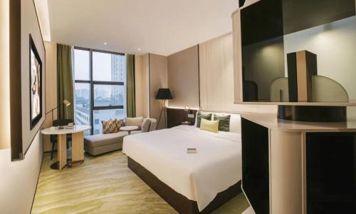 Ένα ή περισσότερα κρεβάτια σε δωμάτιο στο Wuhan Hazens Hotel
