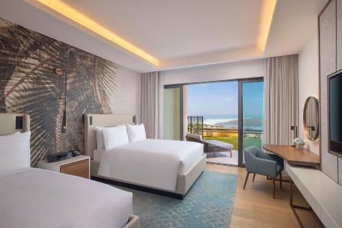 a hotel room with a bed and a large window at Conrad Rabat Arzana in Rabat