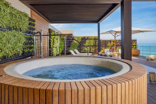 a hot tub on the deck of a house at Conrad Rabat Arzana in Rabat