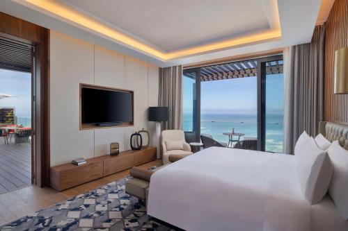 a hotel room with a large bed and a television at Conrad Rabat Arzana in Rabat