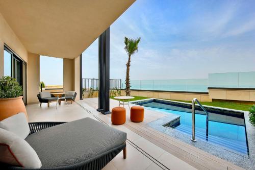 a living room with a swimming pool and a patio at Conrad Rabat Arzana in Rabat