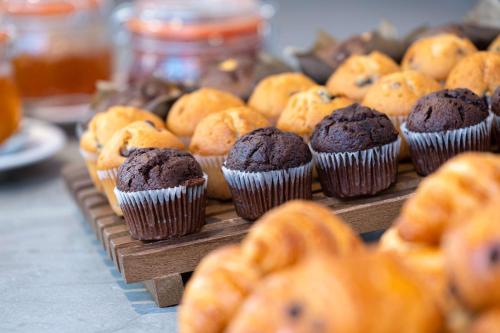 a bunch of muffins and cookies on a table at Hampton By Hilton London City in London