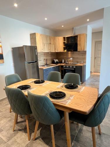 a kitchen with a wooden table and chairs at Sea View Apartments in Durrës