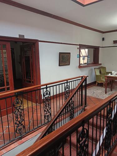 a balcony with a wooden railing and a table at Berg en Zee Guesthouse in Gordonʼs Bay