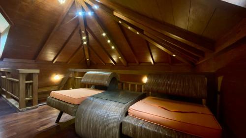 a room with two beds in a wooden cabin at Willo stays beach cottage in Kannur