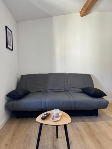 a blue couch in a living room with a coffee table at La perle du centre - Studio in Limoux
