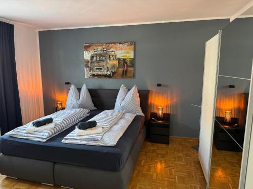 a bedroom with a bed with a painting on the wall at AhA in Lingen