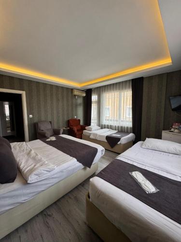 a hotel room with two beds and a living room at deperlas in Atakum
