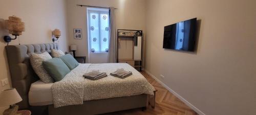 une chambre avec un lit et une télévision à écran plat dans l'établissement Le Colbert - T2 Centre Ville, à Nîmes