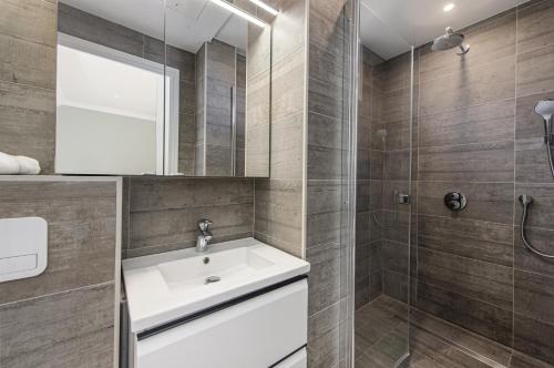 a bathroom with a sink and a shower at CAP D'AIL - SEAFRONT LUXURY PENTHOUSE few minutes from Monaco in Saint-Antoine