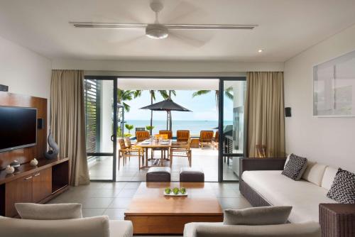 a living room with a couch and a table at Hilton Fiji Beach Resort and Spa in Denarau