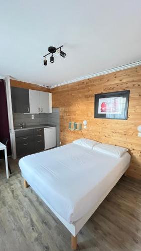une chambre avec un grand lit blanc dans l'établissement Villa Liberté, à Villejuif