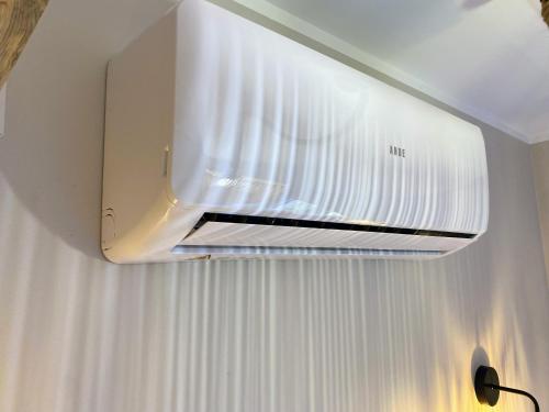 a white air conditioner hanging from a ceiling at Siedlisko pod Kasztanem in Garwolin