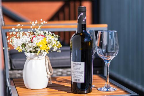 a bottle of wine and a wine glass on a table at Apartmán Horček, Terchová in Terchová