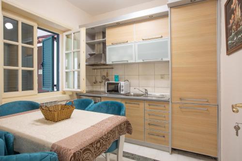 a kitchen with a table and chairs and a microwave at Luxury Apartments Montesan in Sveti Stefan