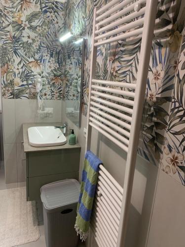a bathroom with a sink and a toilet and a mirror at Anzio (RM), zona Santa Teresa in Anzio