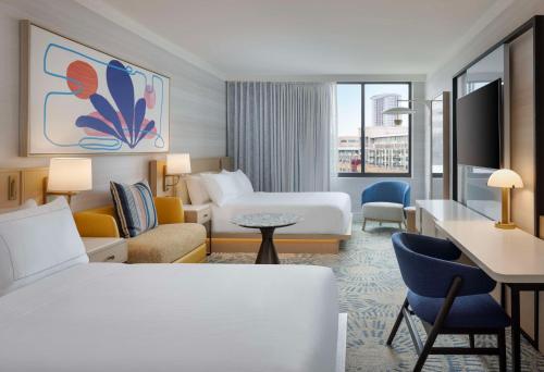 a hotel room with a bed and a desk at The Highland Dallas, Curio Collection by Hilton in Dallas