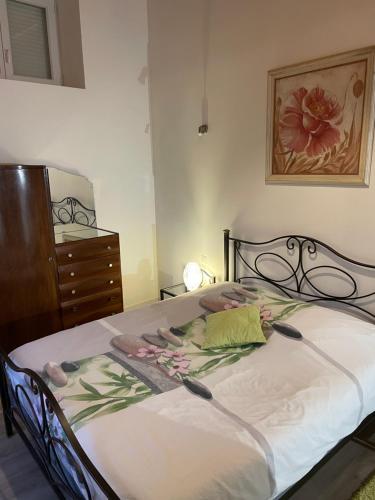 a bedroom with a large bed with a dresser and a dresser at La Maison de Georgette in Versols-et-Lapeyre