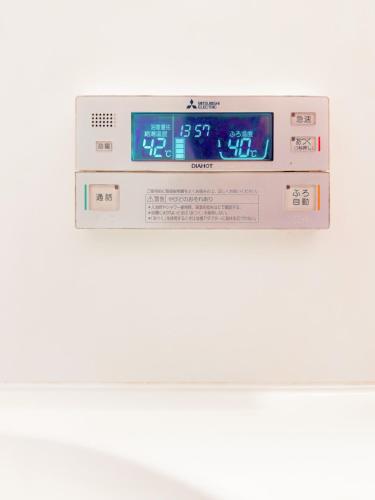 a digital clock on top of a machine at Yuki's house - Kyoto single-family house, 3 minutes to the nearest bus stop in Kyoto