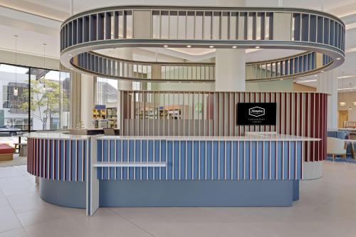 a lobby with a blue counter in a building at Hampton By Hilton Guanacaste Airport in Liberia