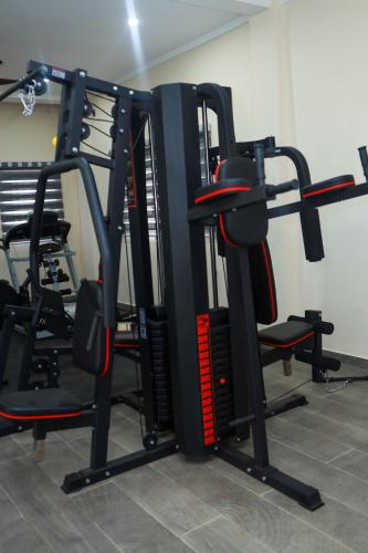 a gym with several tread machines in a room at Judah Chaim Apartments in Ashaiman