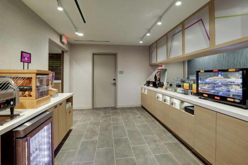 a large kitchen with a counter in a restaurant at Home2 Suites By Hilton Sanford in Sanford