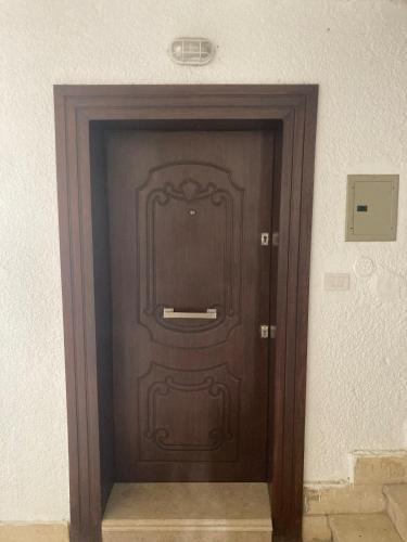 a wooden door in a building with at First Row to Pyramids Studio in Kafrat Naşşār