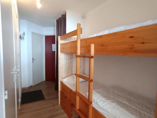 Ce lit superposé se trouve dans un dortoir avec une échelle. dans l'établissement Appartement cosy rénové, sur les pistes, balcon, parking - FR-1-445-159, à Montgenèvre