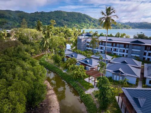 an aerial view of a resort with a river at Canopy By Hilton Seychelles Resort in Anse a La Mouche
