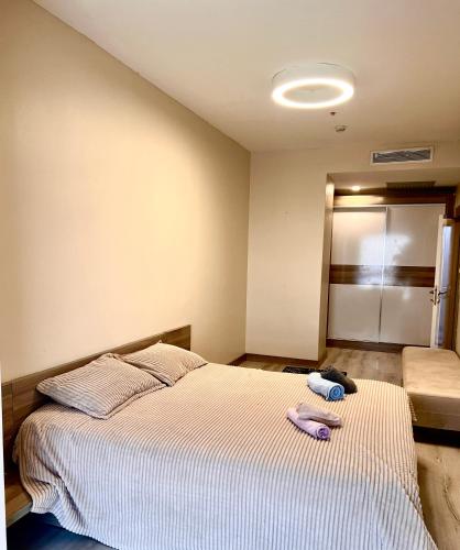 a bedroom with a bed with two towels on it at Cozy Studio in Esenyurt