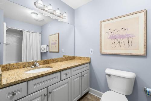 a bathroom with a sink and a toilet at The Oasis at Orange Beach 2206 (Phoenix West II) in Orange Beach