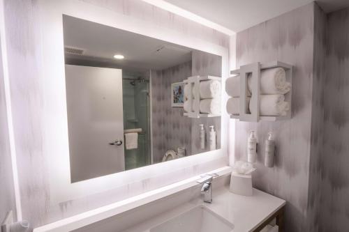a white bathroom with a mirror and a sink at Hampton Inn St Augustine Downtown Historic Distric in Saint Augustine