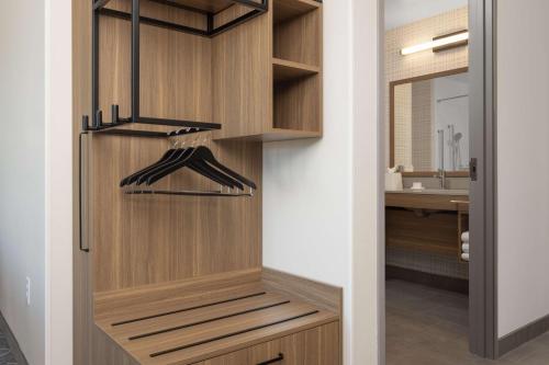 a walk in closet with wooden cabinets and a sink at Hampton Inn & Suites Cottonwood, Az in Cottonwood